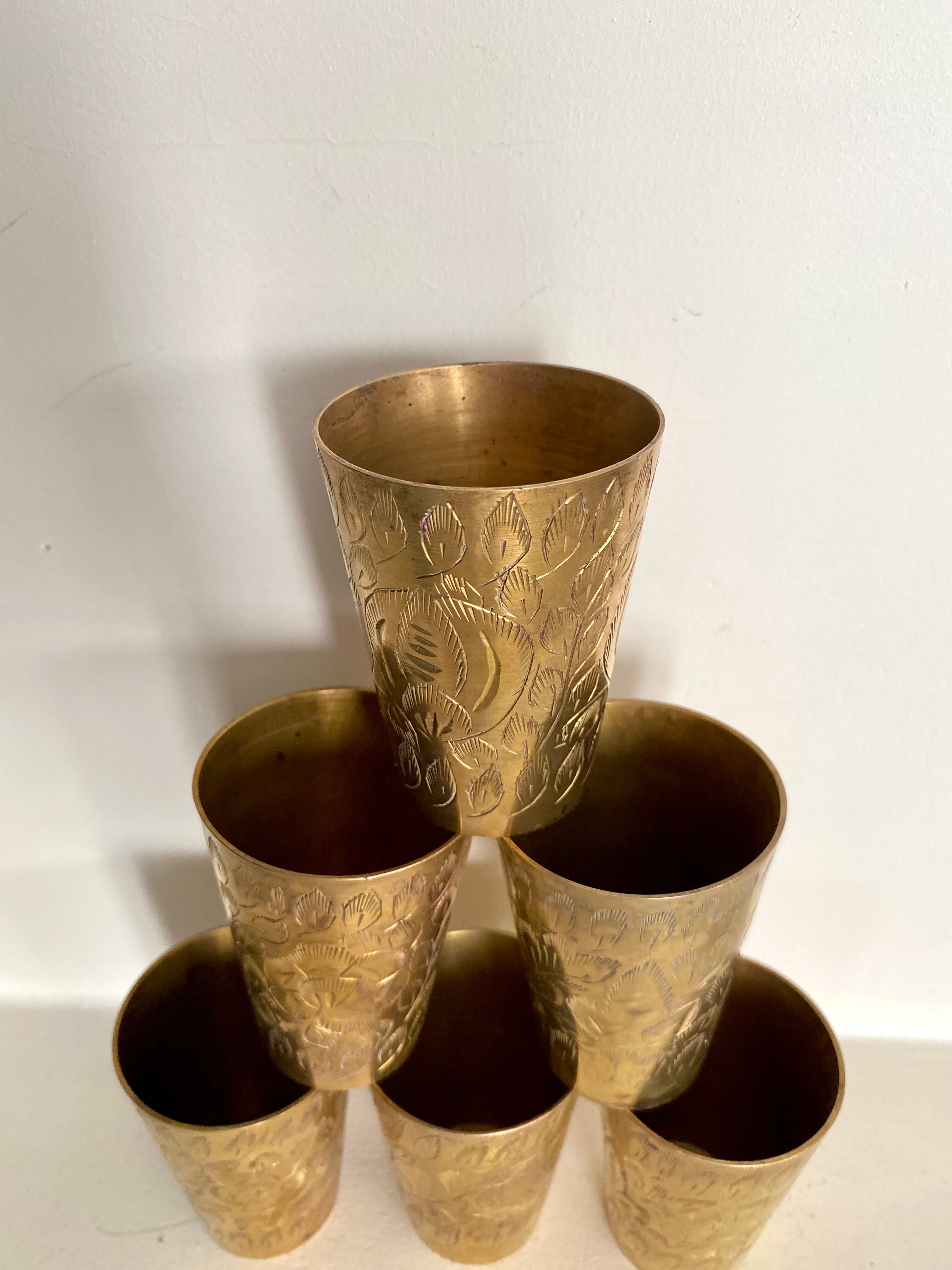 Six chiseled metal glasses