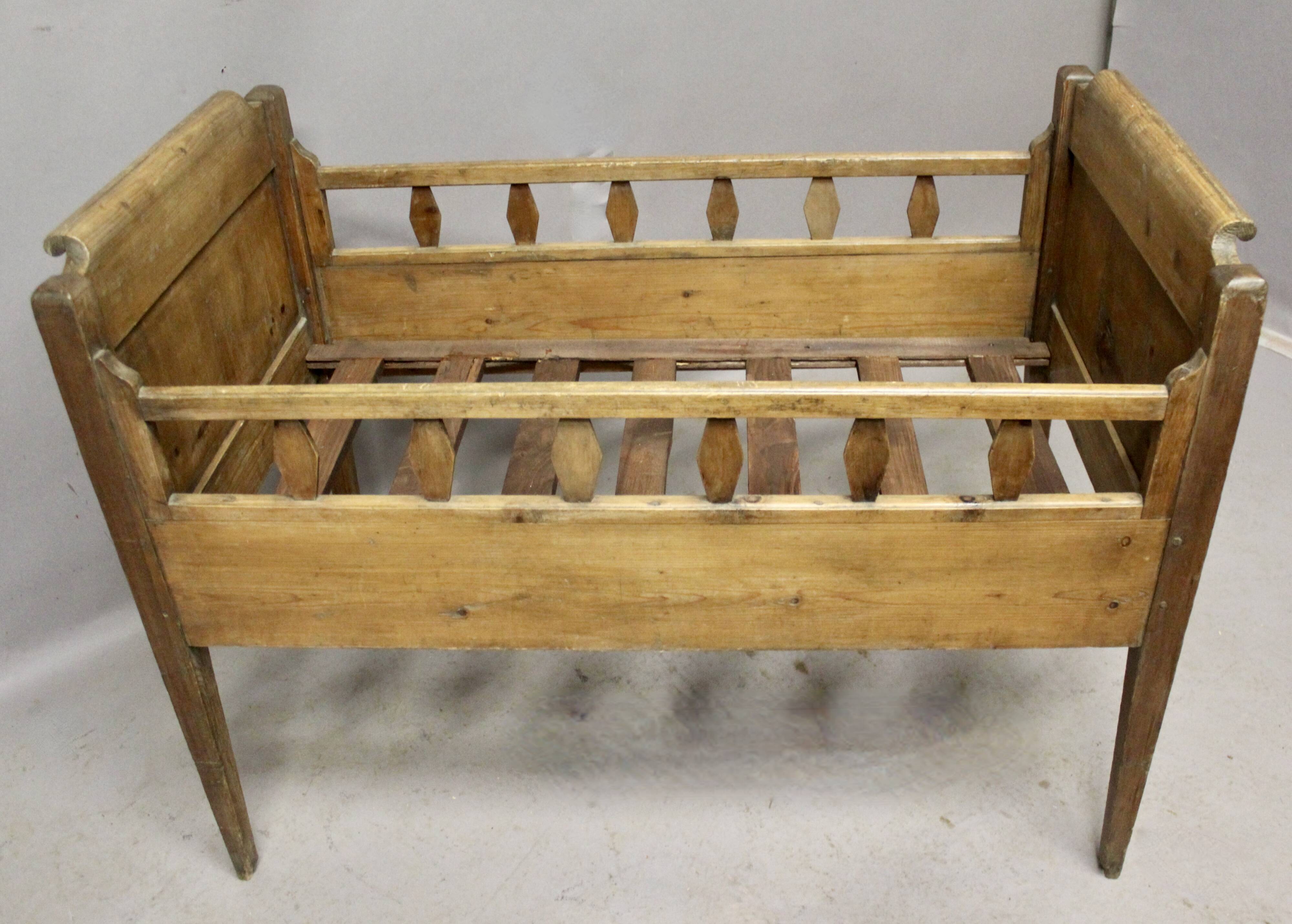 Antique children's bed from the 19th century.