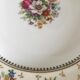 4 mismatched flat plates with floral patterns. Porcelain. Stamped