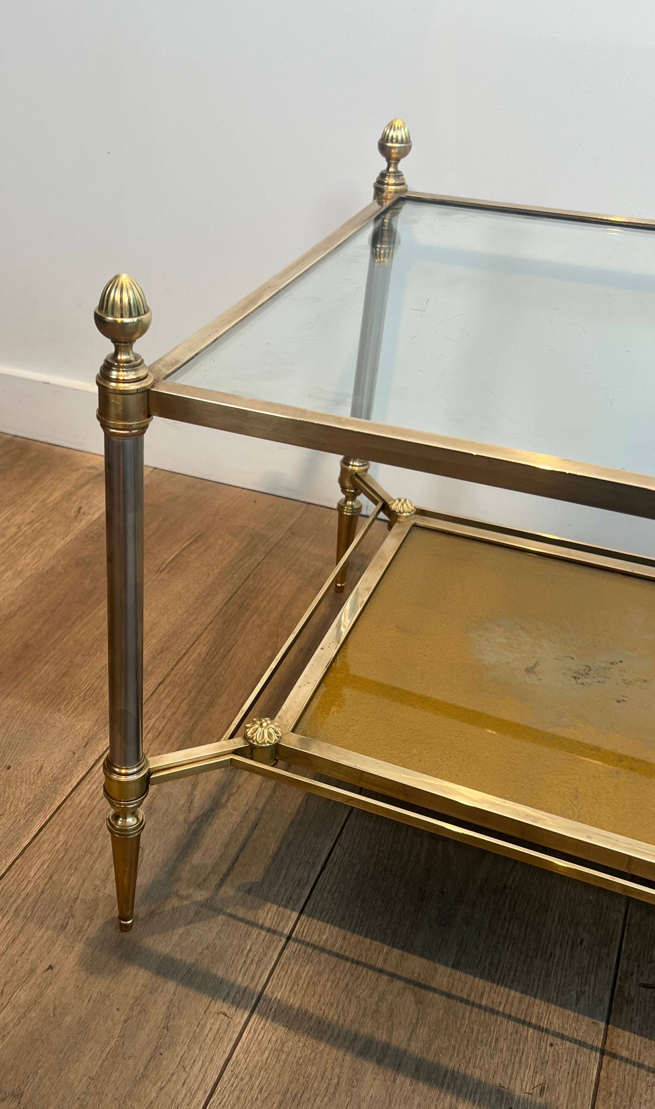 Coffee table in brass, brushed steel, glass, and gilded eglomisé mirror from Maison Jansen.