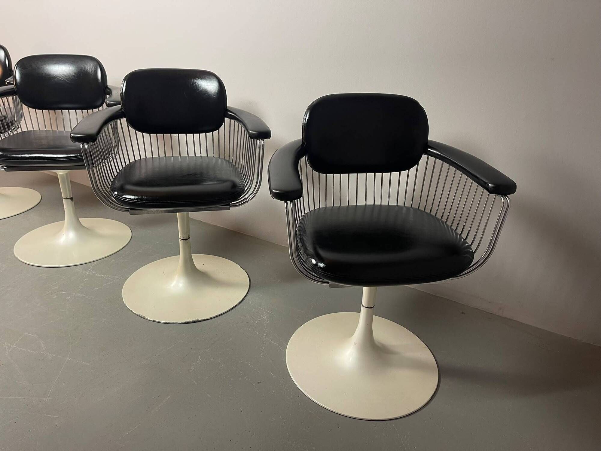 A striking set of four vintage swivel dining chairs