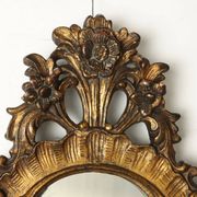 Antique Rococo-style mirror, gilded linden decorations, 20th century.