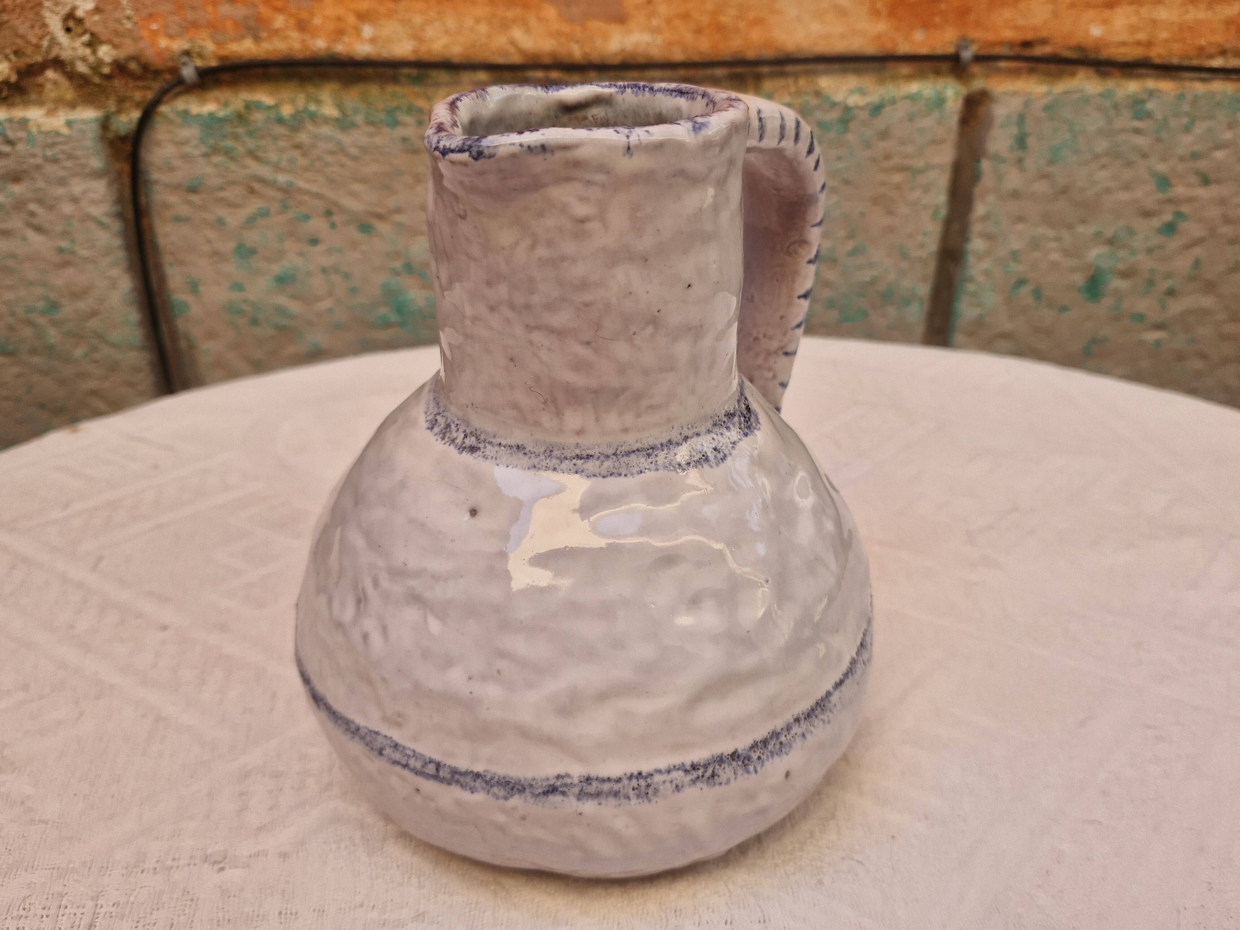 Old stamped glazed terracotta jug