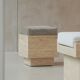 Cubic travertine stool with velvet cushion