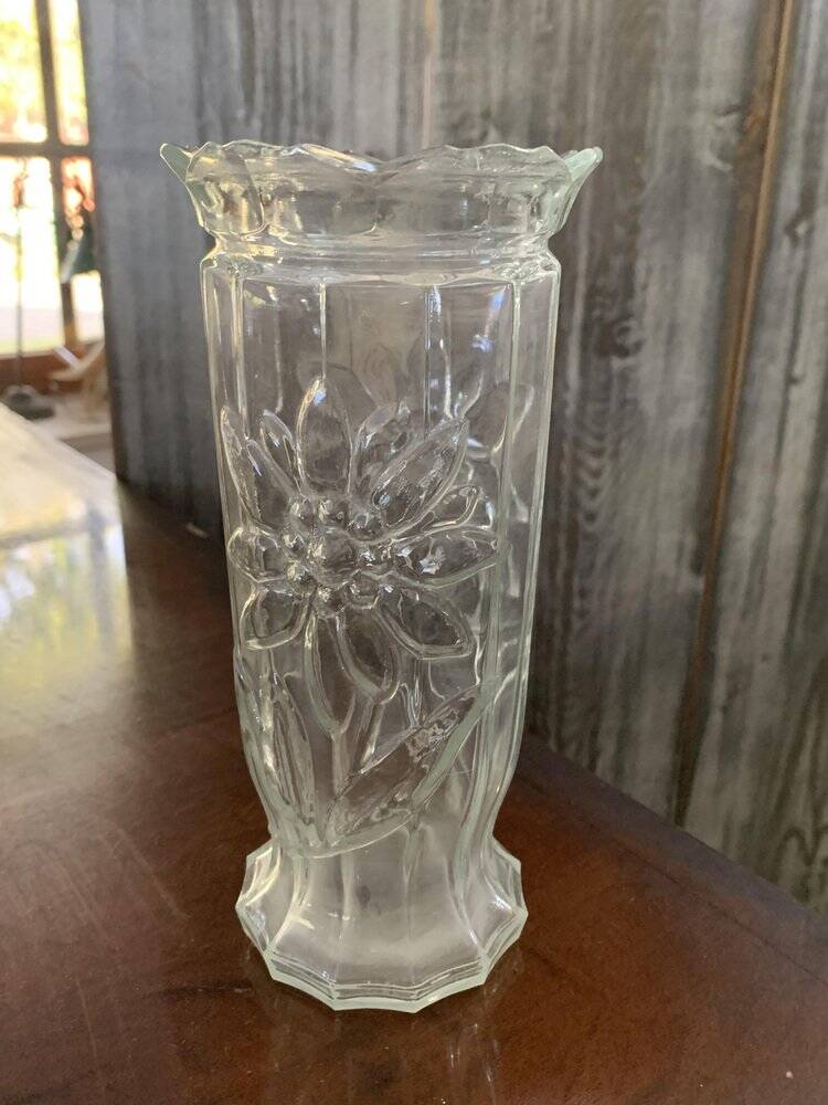 Transparent glass vase with relief floral decoration from the 1980s, fluted neck and polygonal base.