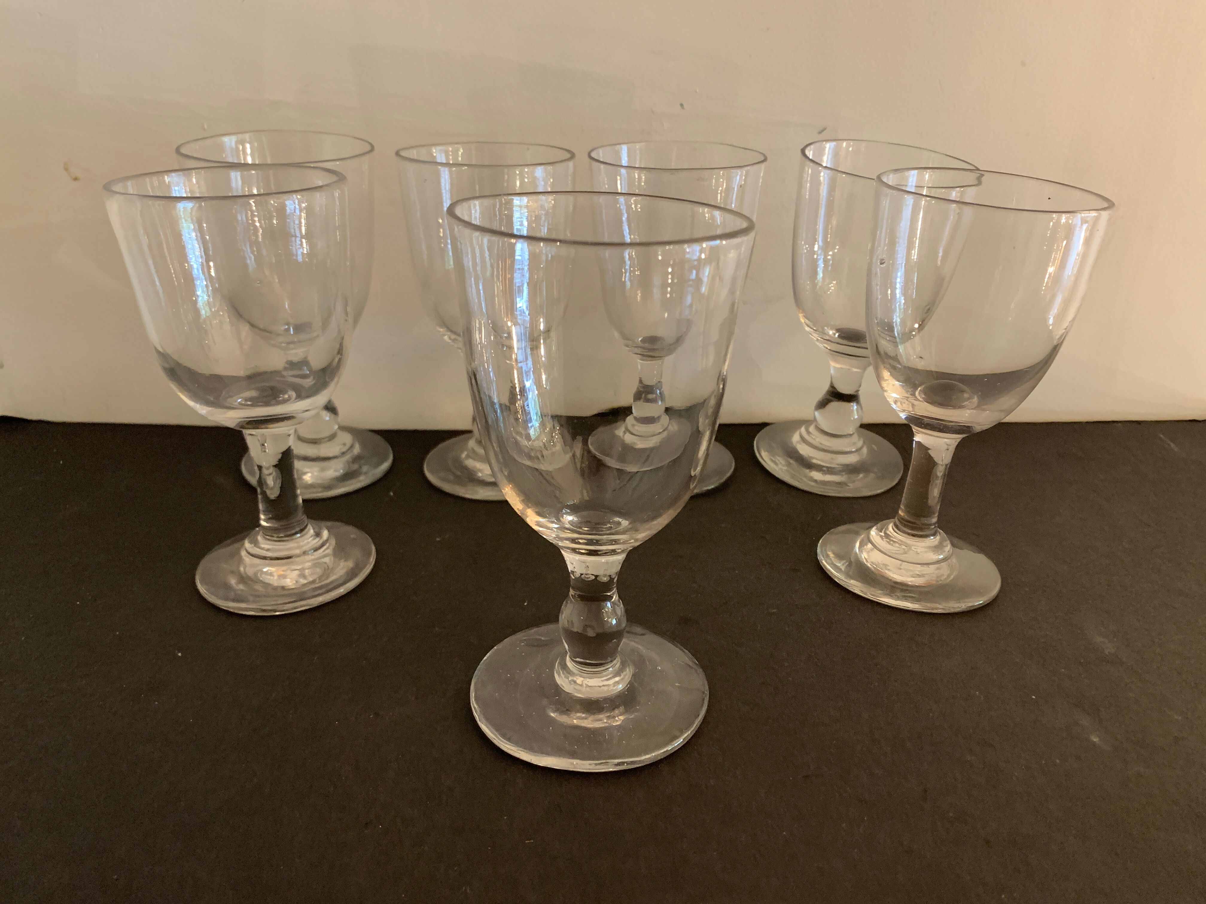 7 antique blown foot glasses