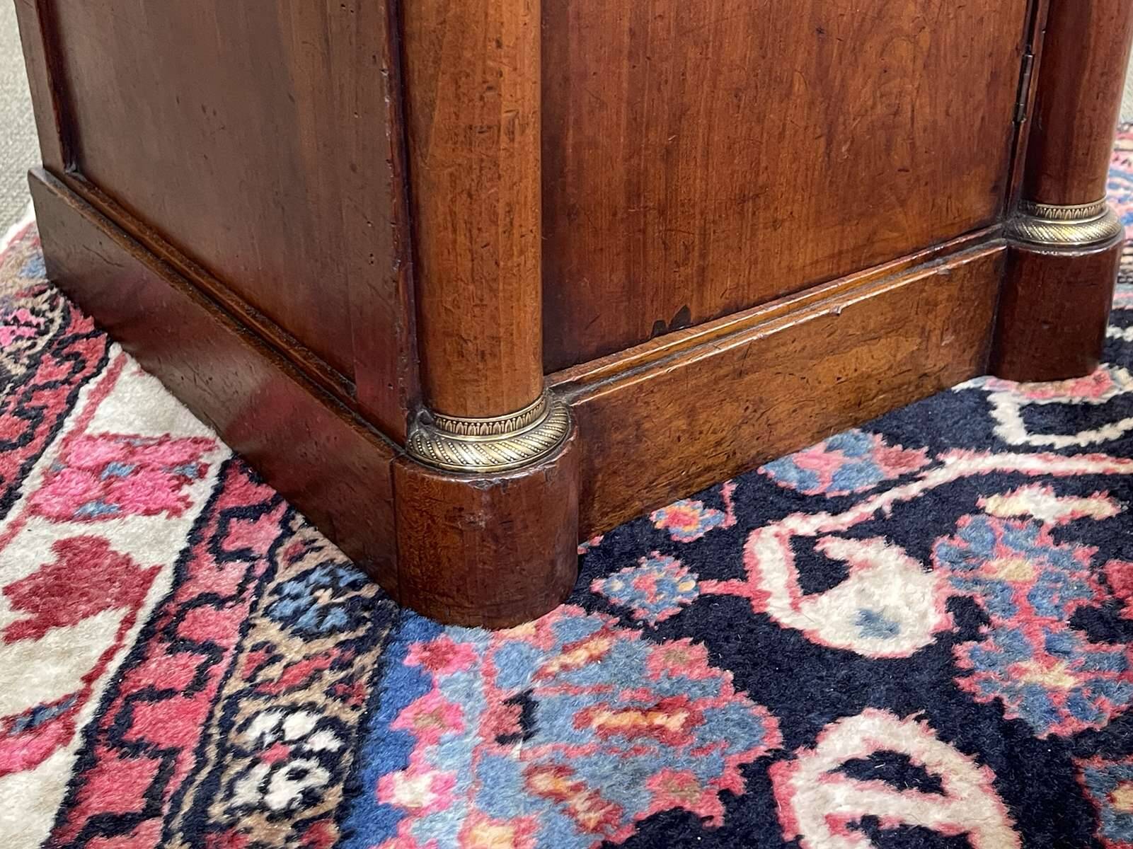 Empire bedside table from the 19th century in cherry wood and black marble.