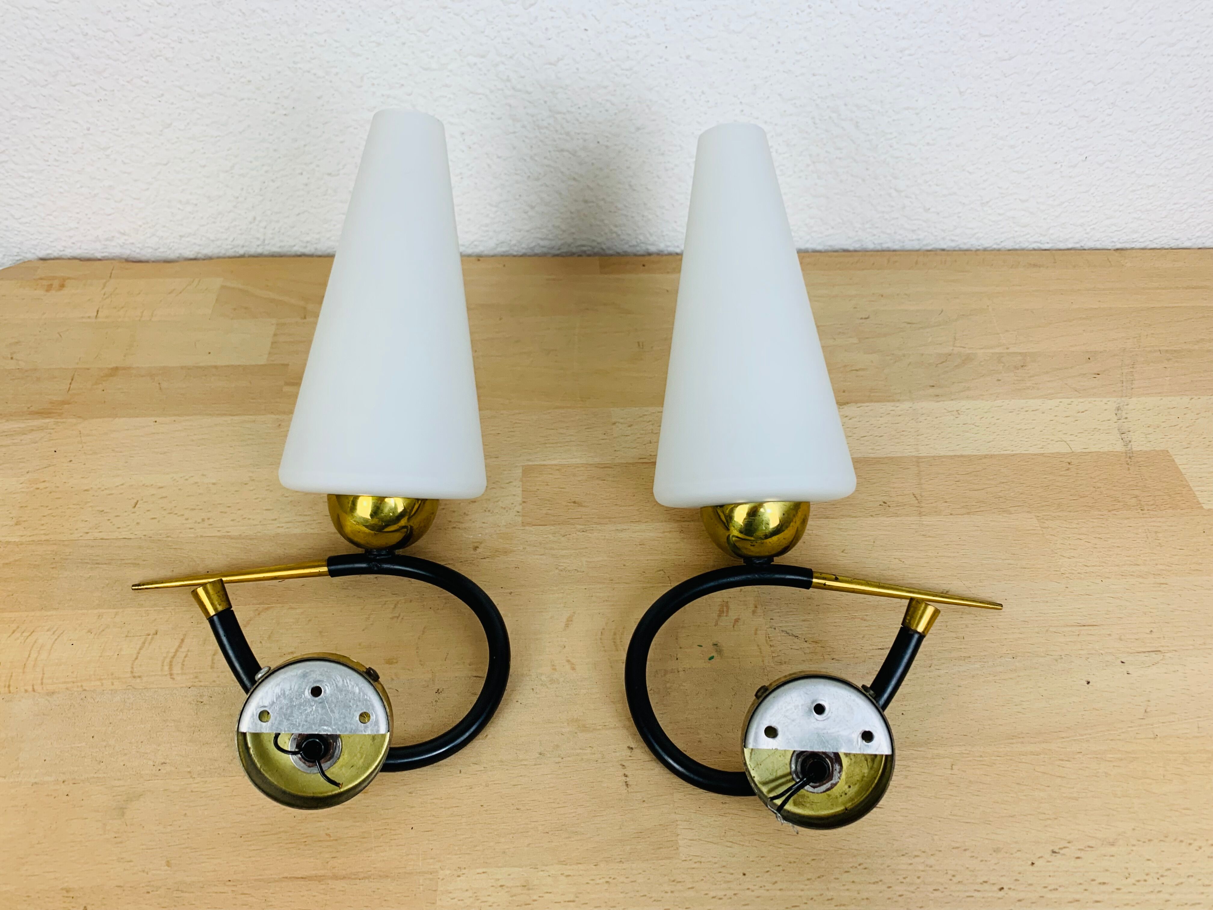 Pair of Arlus 50s opaline black and golden brass wall lamps