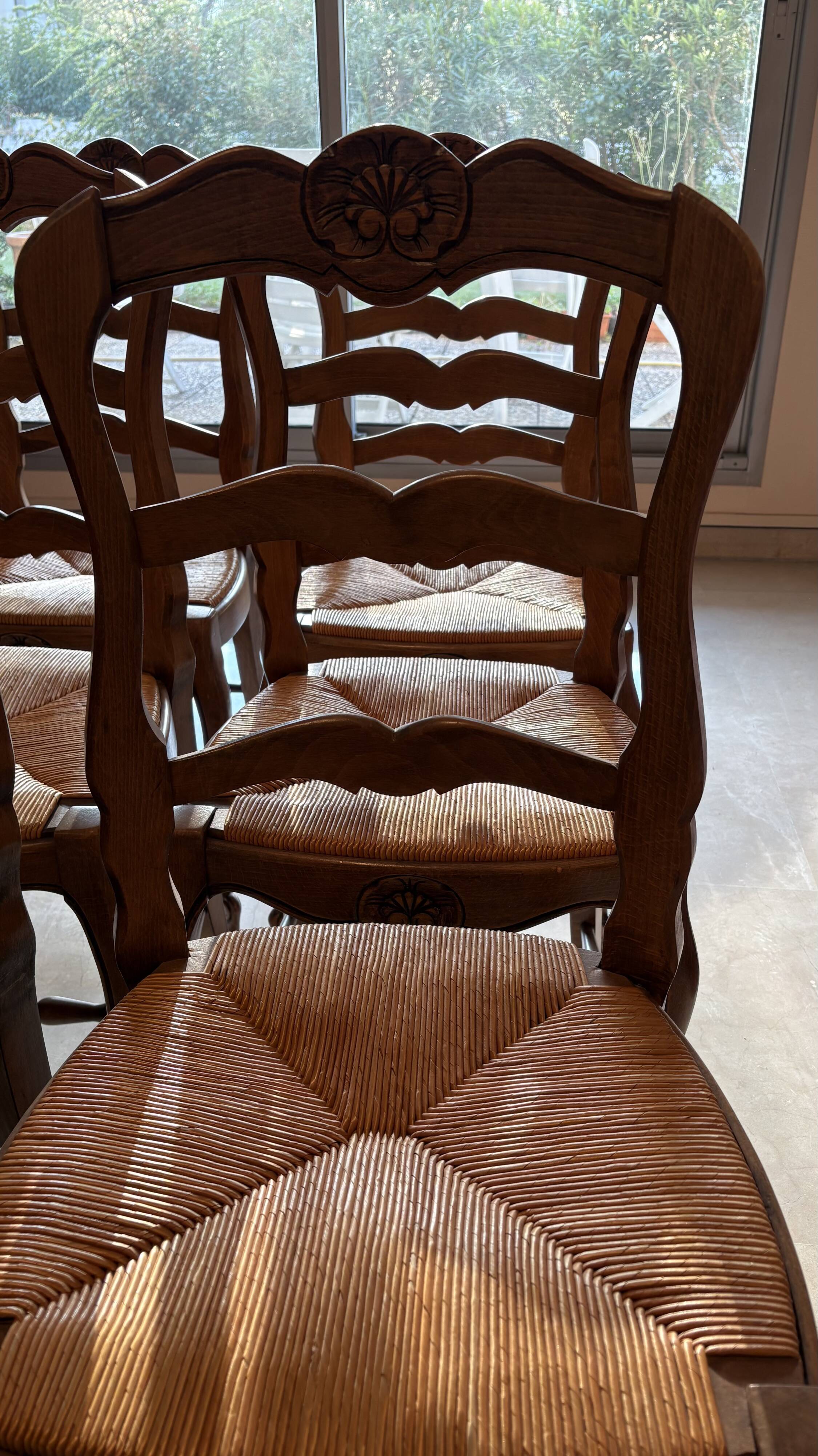 Set of 6 wooden chairs with straw seats.