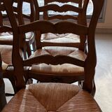Set of 6 wooden chairs with straw seats.