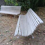 Pair of antique wooden slatted benches with wrought iron legs.