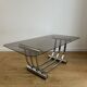 Smoked glass coffee table and chrome base by Yves Boutboul