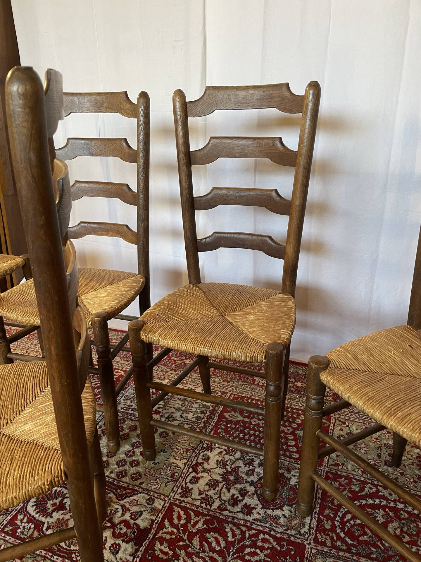 Set of 5 antique oak and straw chairs.