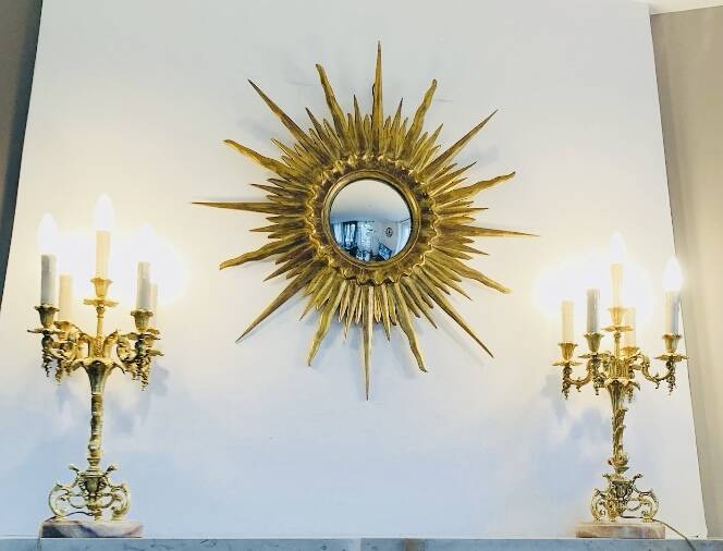 Massive gilded bronze chandeliers from the mid-20th century with marble bases.