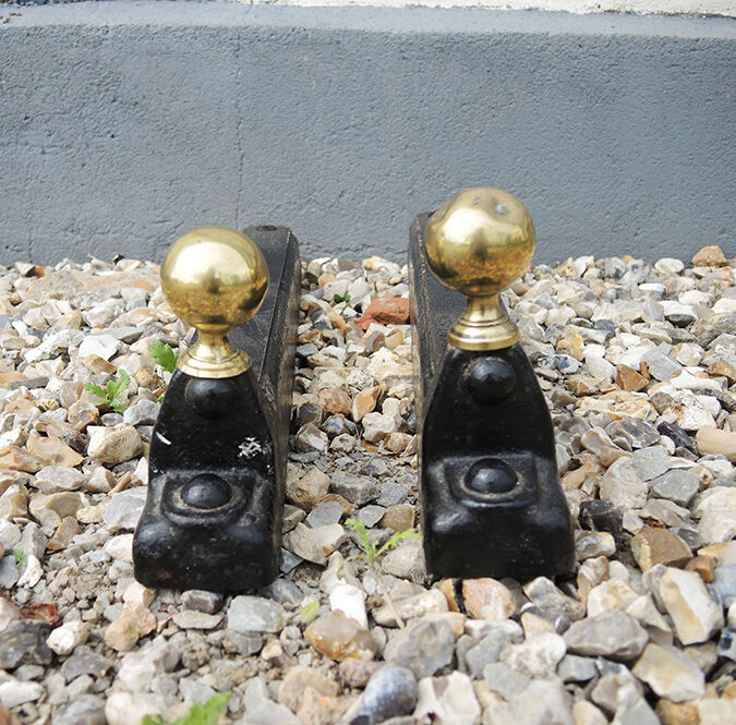 Old cast iron and xl brass andirons in neo classical style