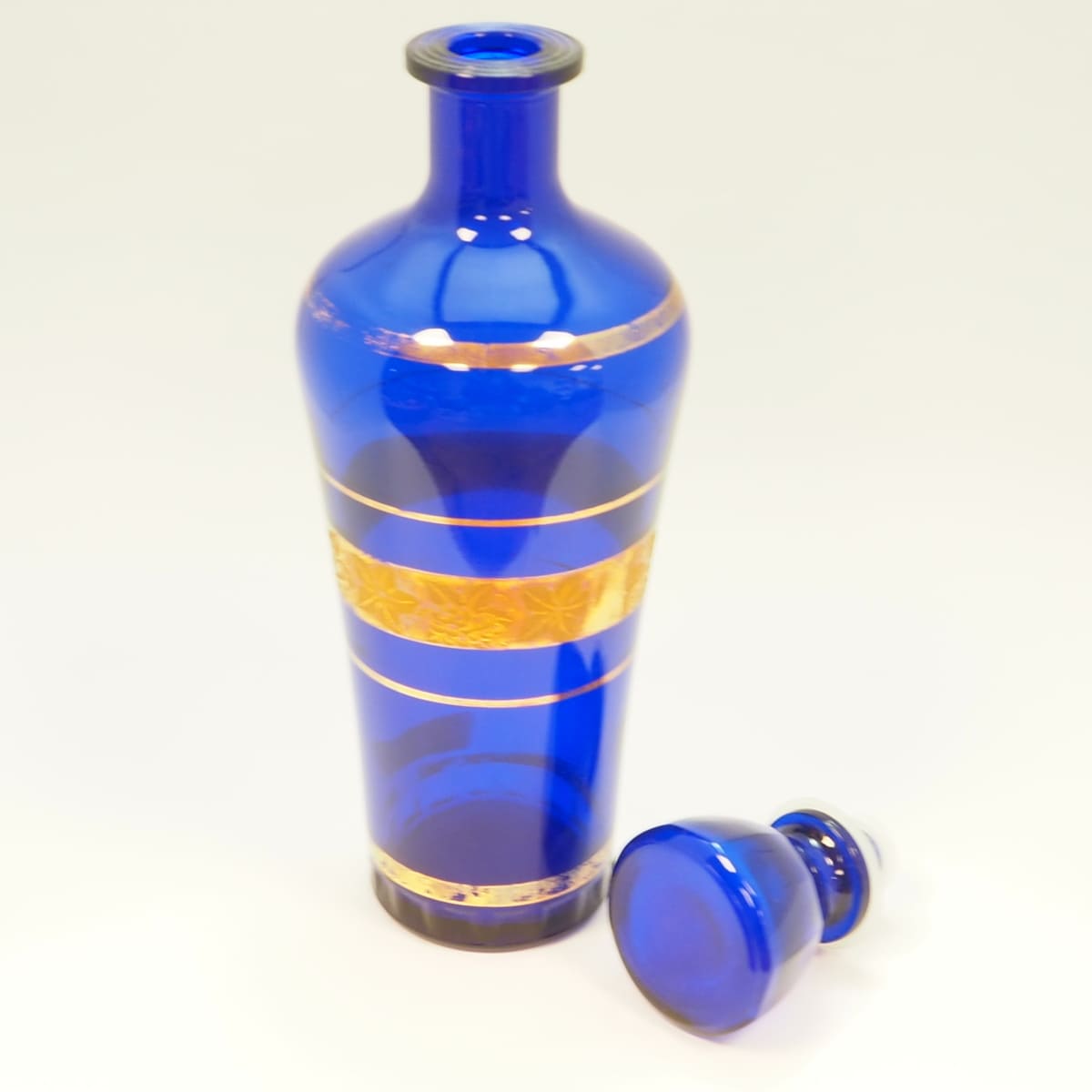 Blue glass decanter with gold decoration