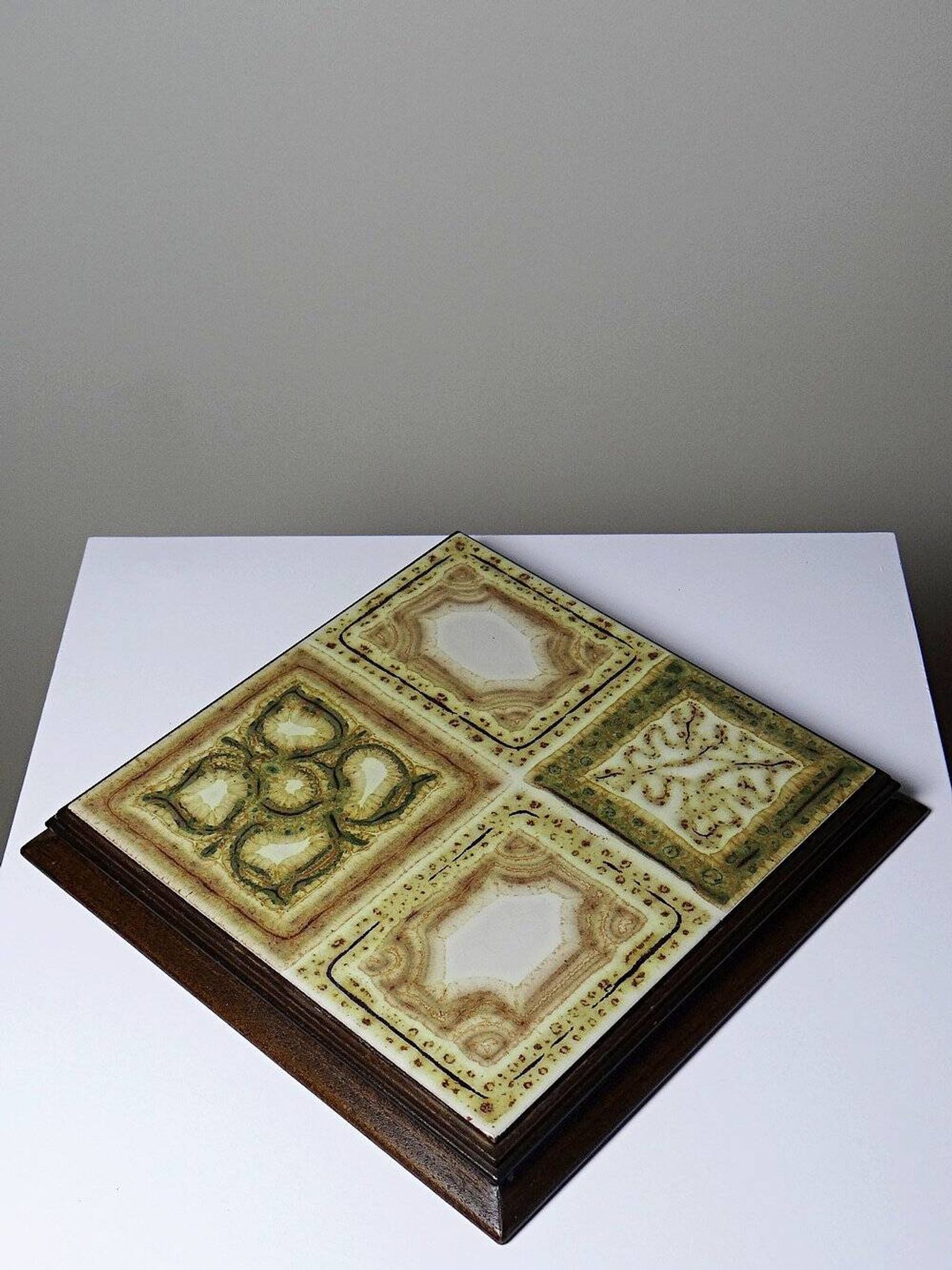 Vintage ceramic and wooden trivet, circa 1960-1970.