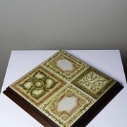 Vintage ceramic and wooden trivet, circa 1960-1970.