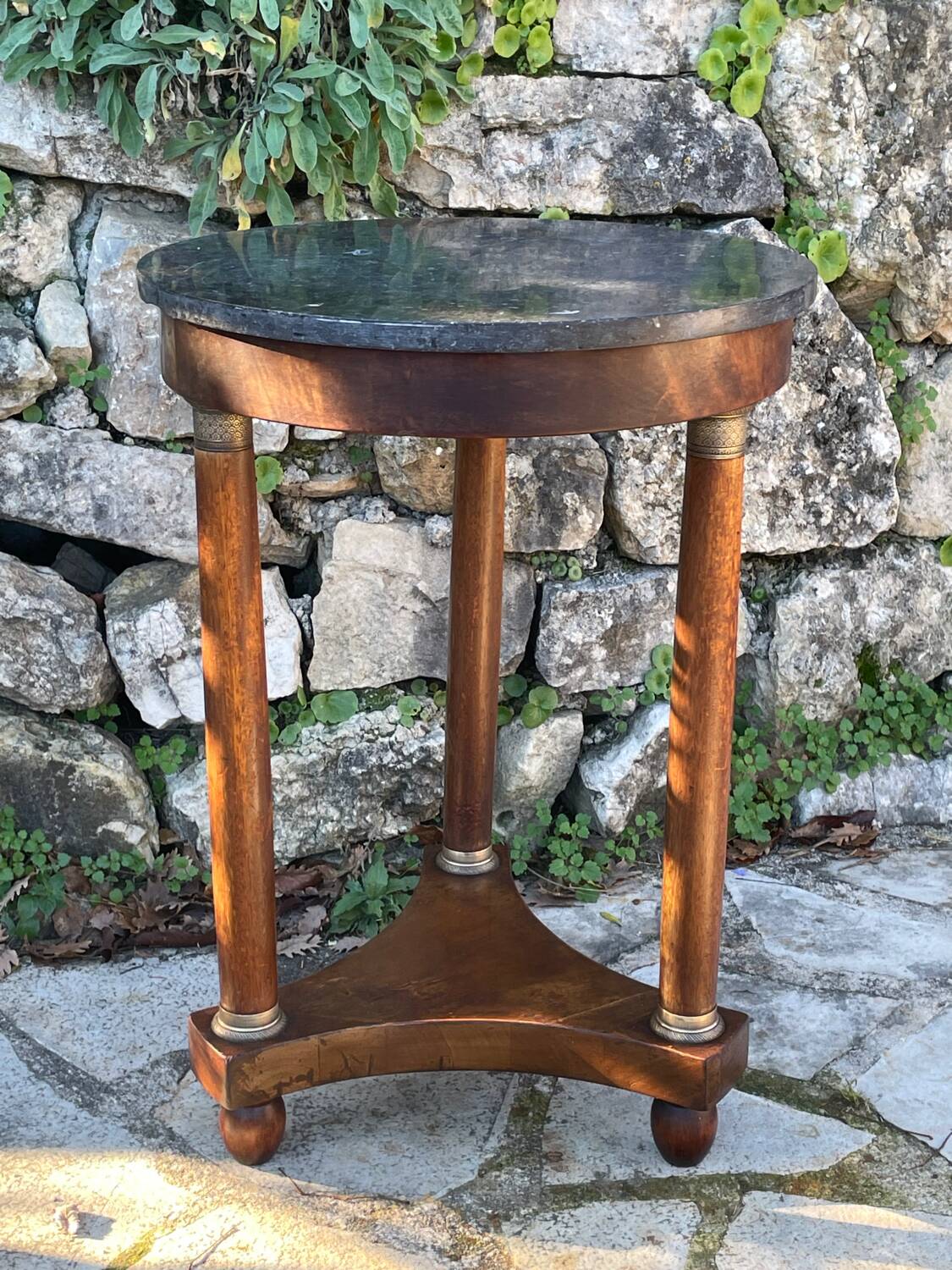 Empire style mahogany and mahogany veneer tripod pedestal table