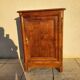 Furniture with a cherry wood door.