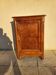 Furniture with a cherry wood door.