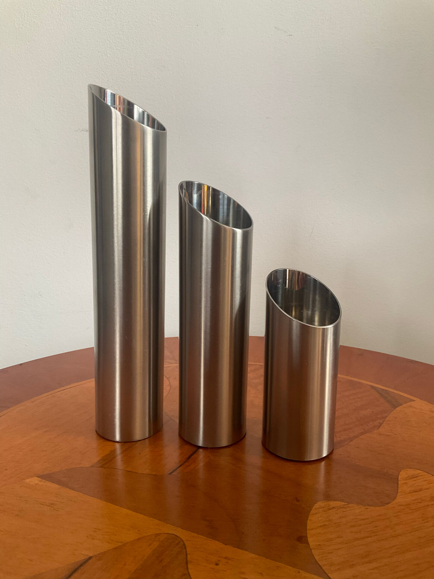 Vintage trio of brushed stainless steel candle holders