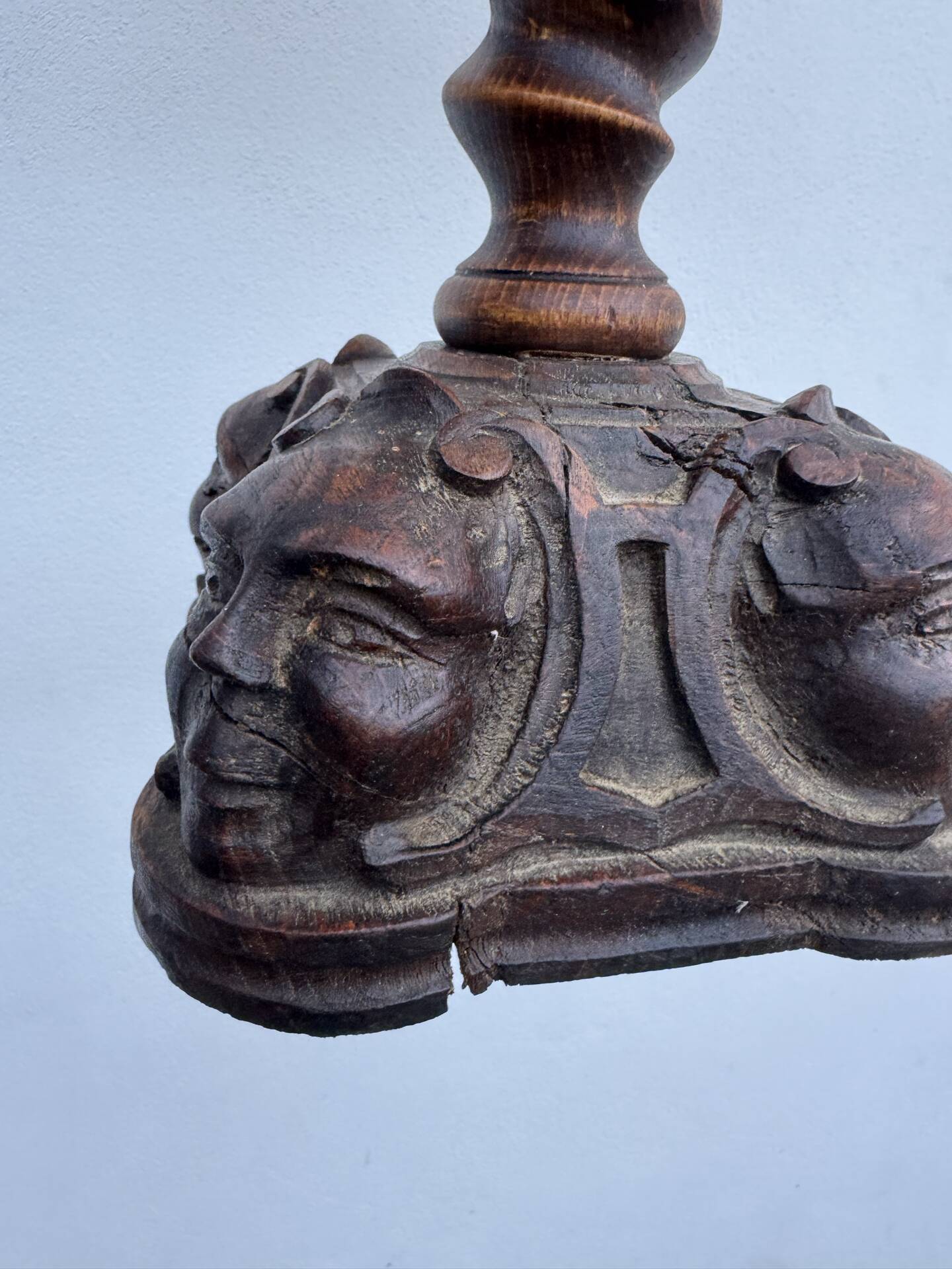 Sculpted wooden lamp with faces, antique.