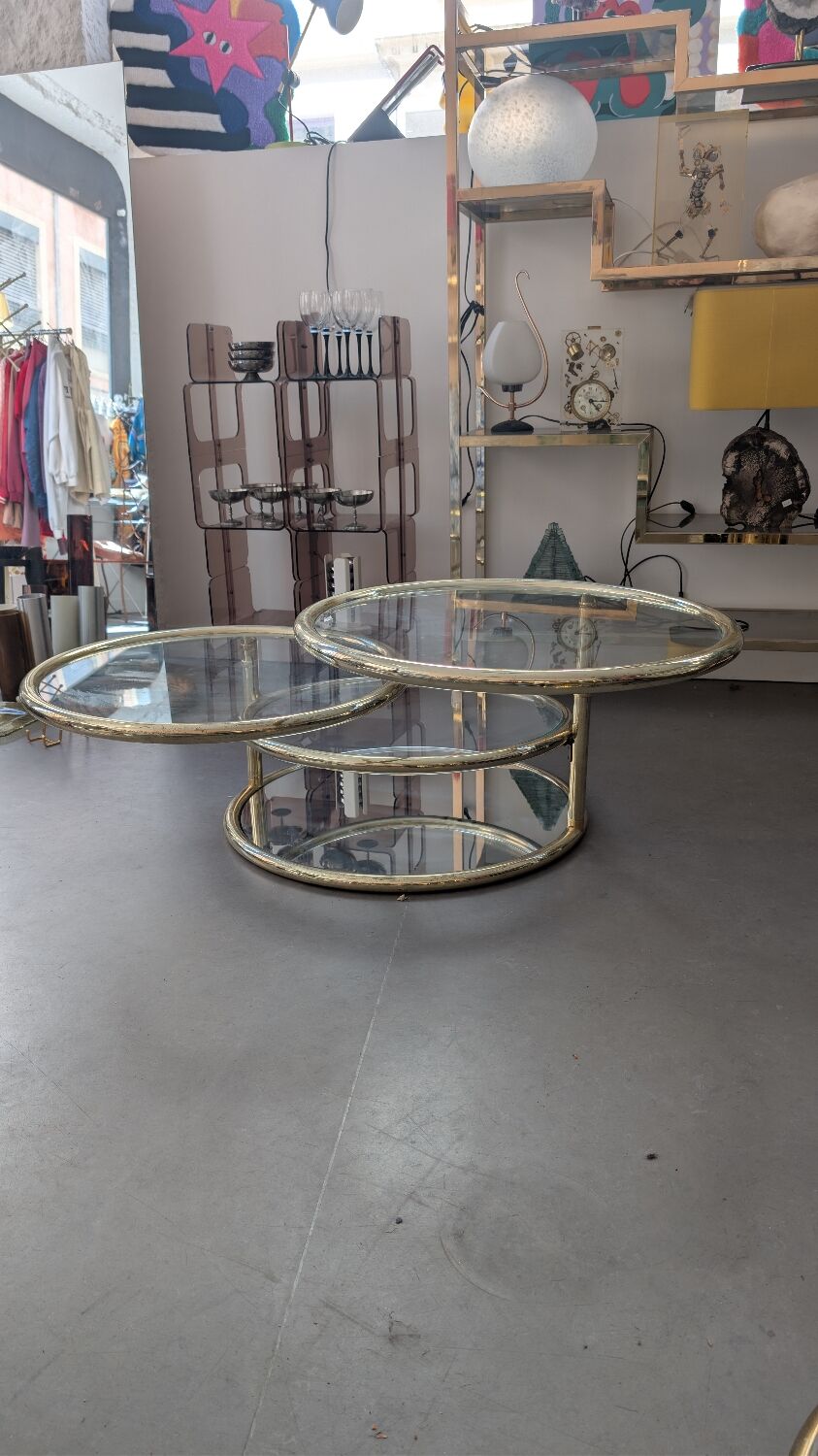 Gold brass coffee table with rotating trays.
