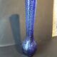 Vintage cobalt blue glass vase with foliage decoration.
