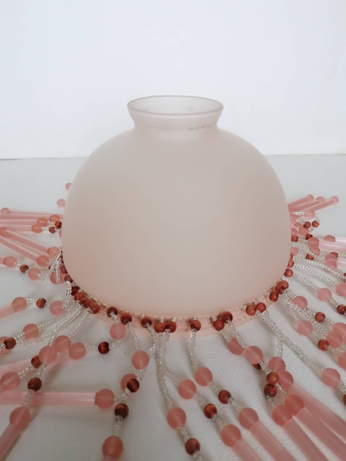 Pink glass wall lamp with garland of pearls