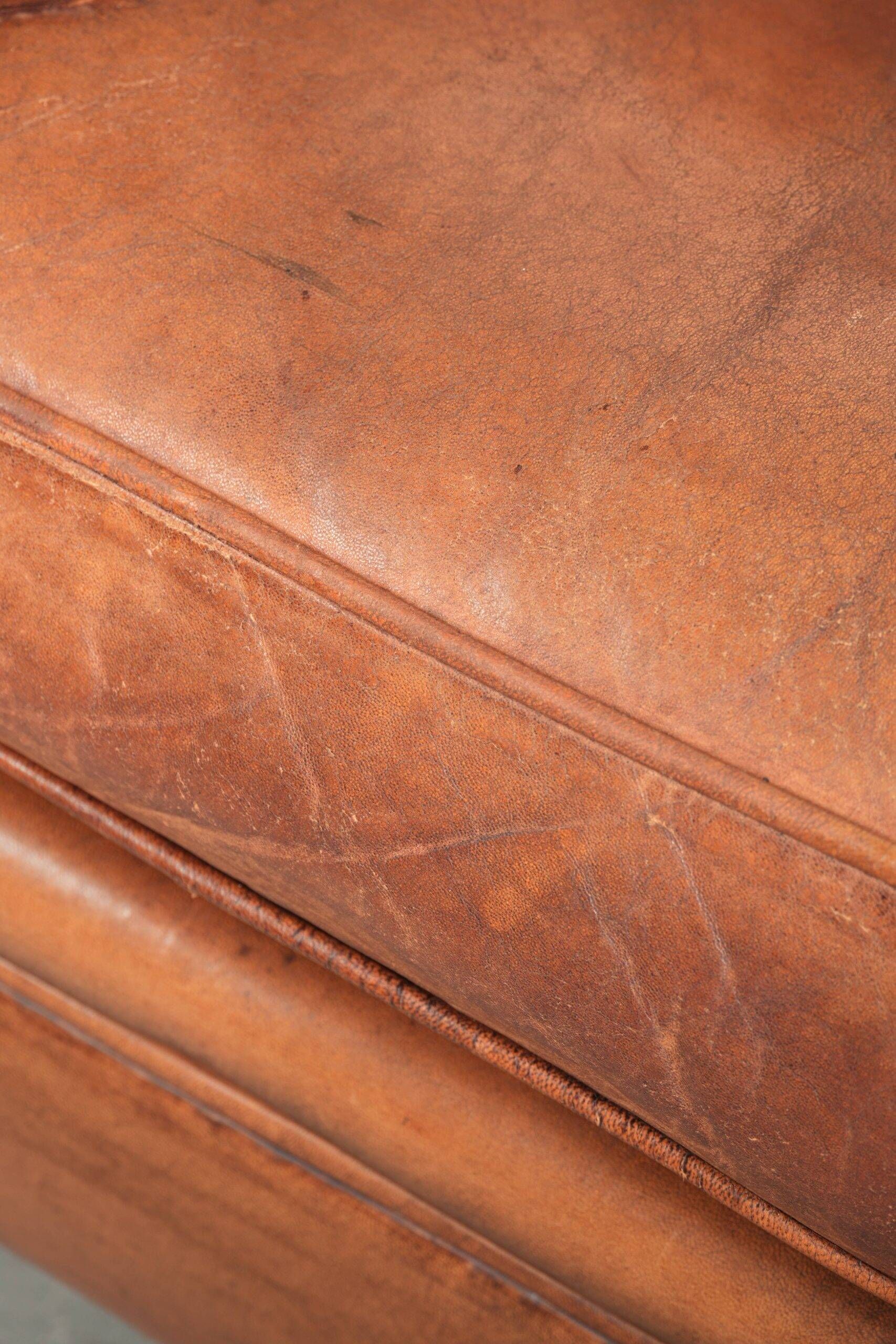 Comfortable vintage sheepskin armchair finished with decorative nails