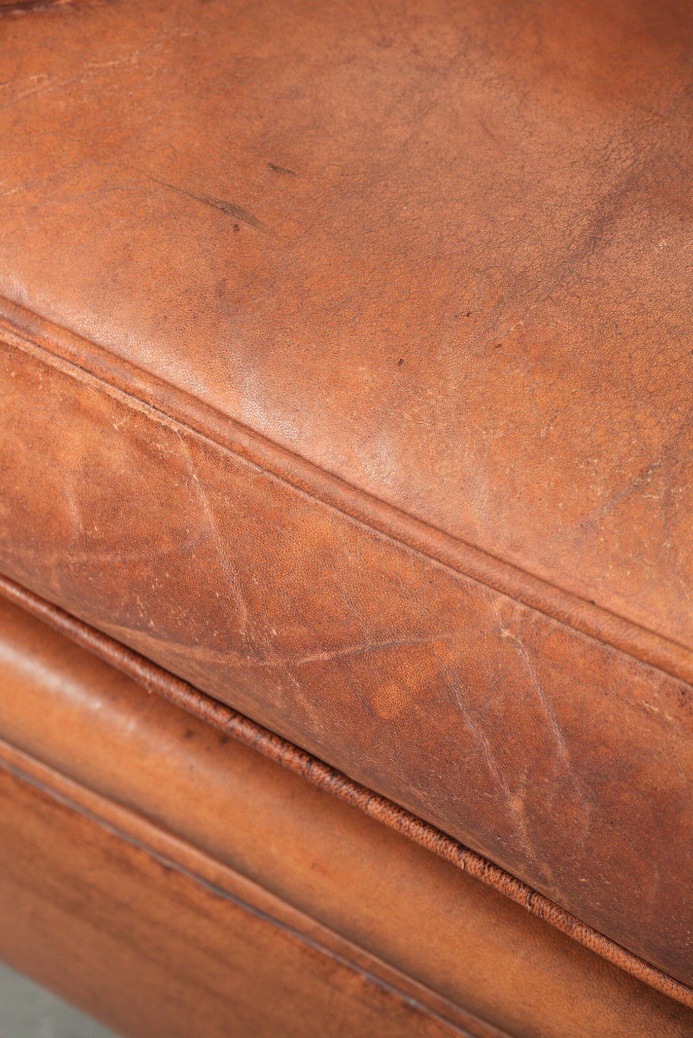 Comfortable vintage sheepskin armchair finished with decorative nails