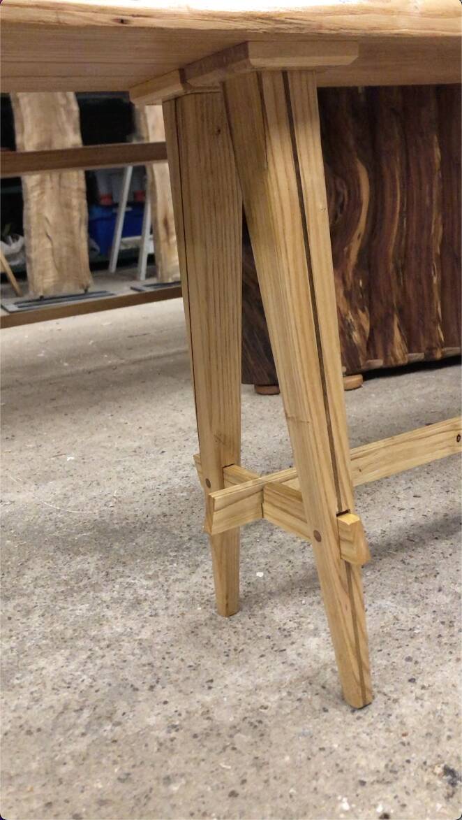 Chestnut and walnut solid table and benches with a central leg.