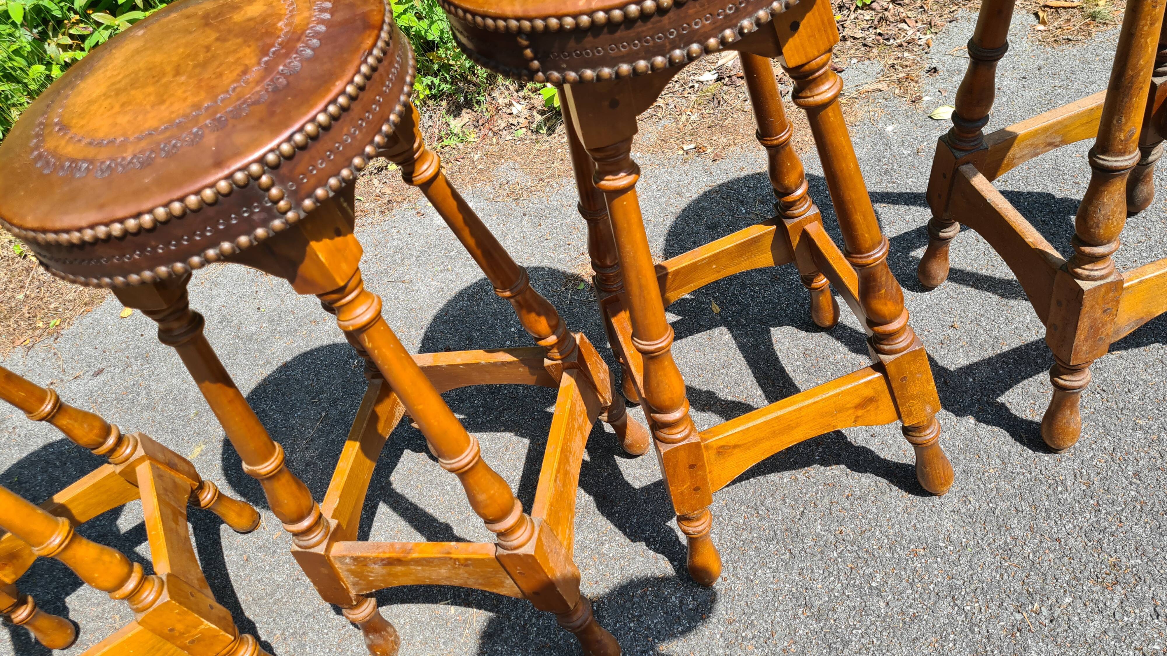 4 old leather and wood stools