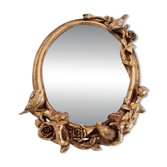 Oval wall mirror in Art Nouveau style with a decoration of birds and roses.