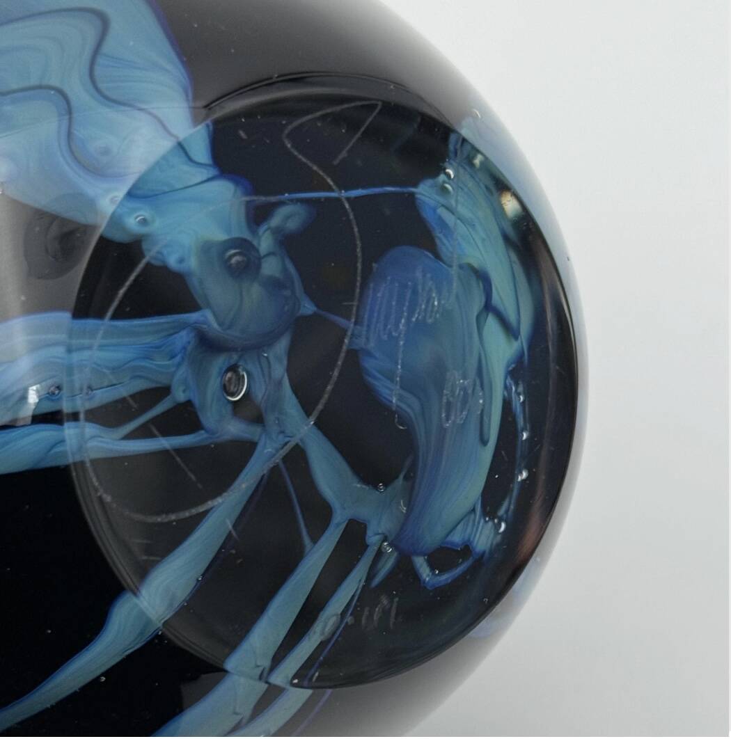 Double-lined blown glass vase with flower inclusions.