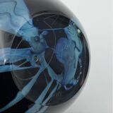 Double-lined blown glass vase with flower inclusions.