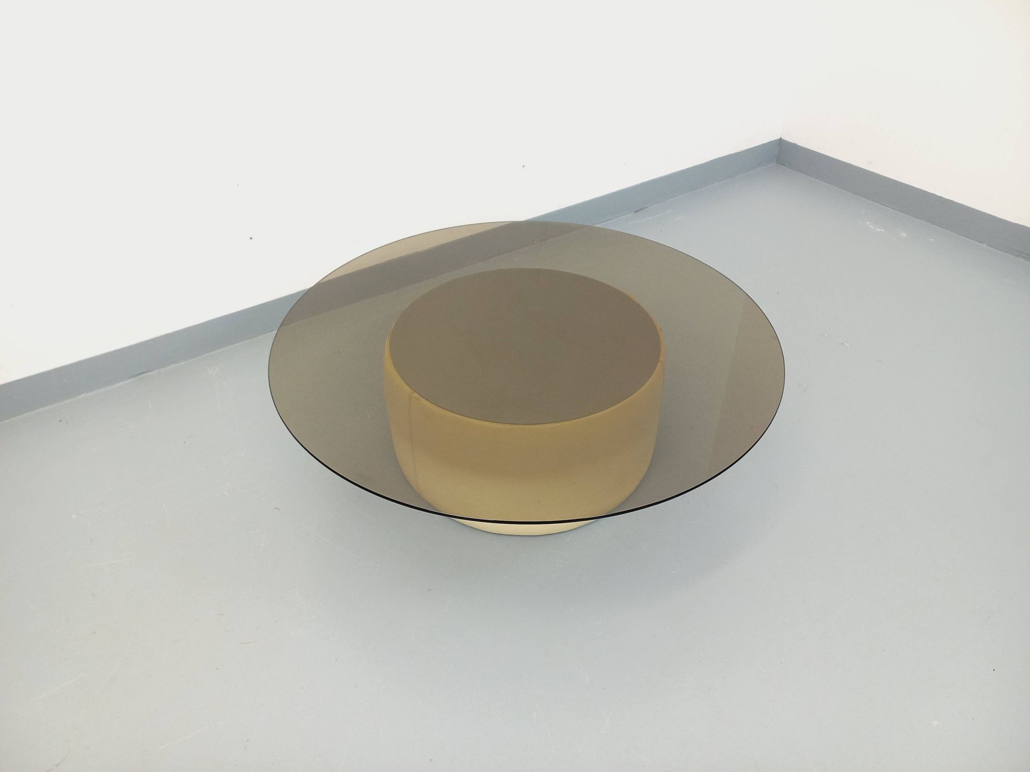 Vintage round coffee table in glass, leather, and metal in Space Age style from the 70s.