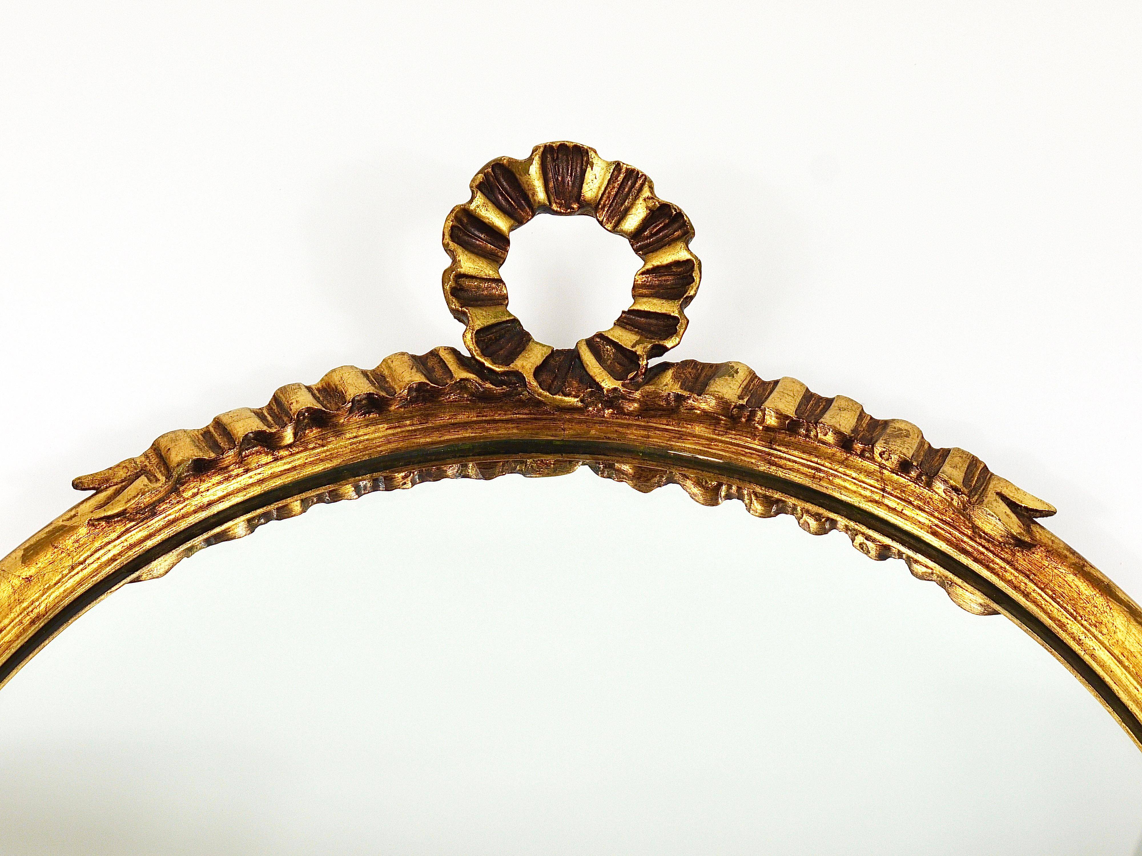 Round wall mirror in gilded wood, mid-century, C. Allodi & G. Subelli, Italy, 1950s.