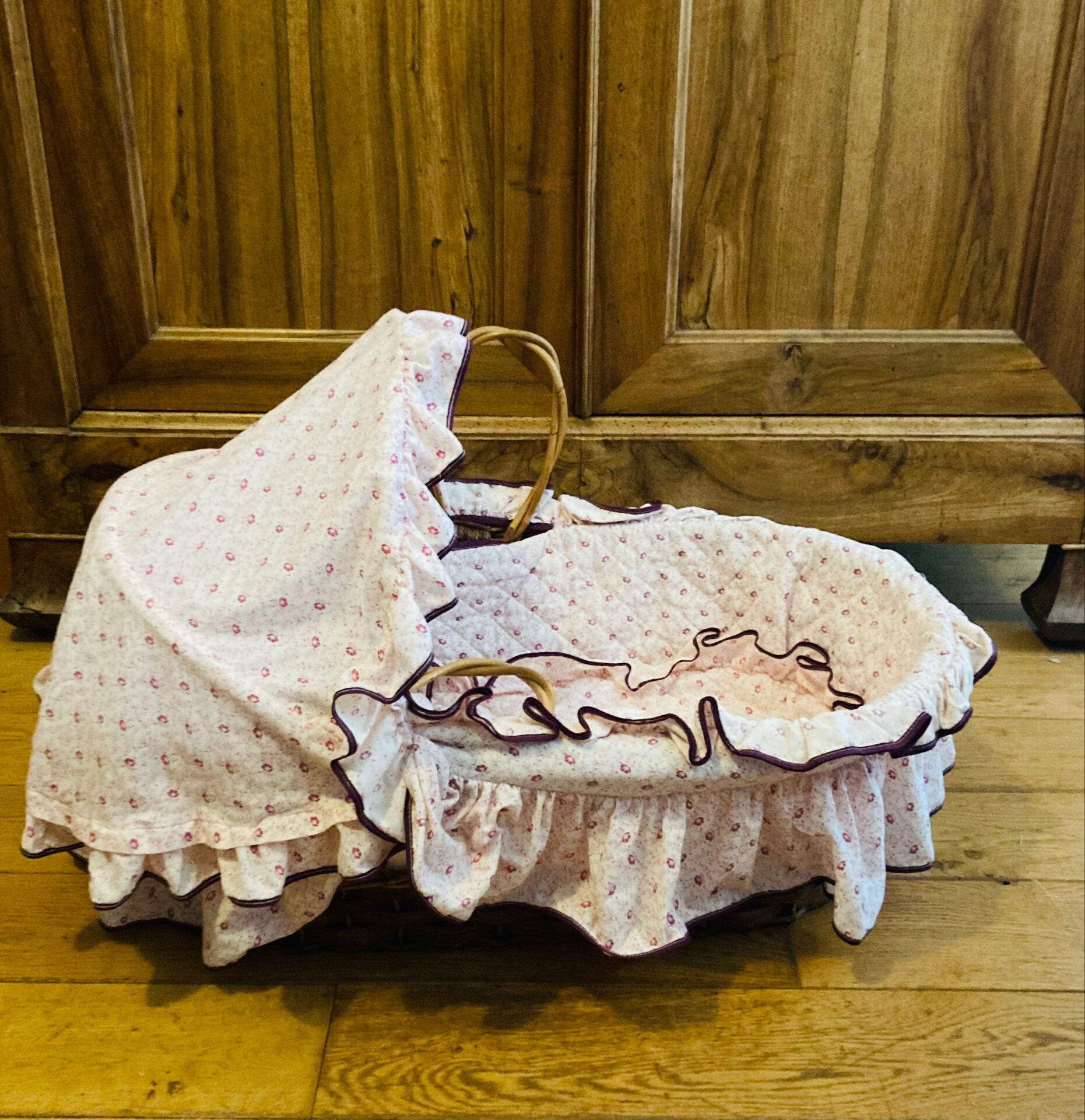 1960s wicker cradle with mattress and drapes.