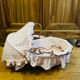 1960s wicker cradle with mattress and drapes.