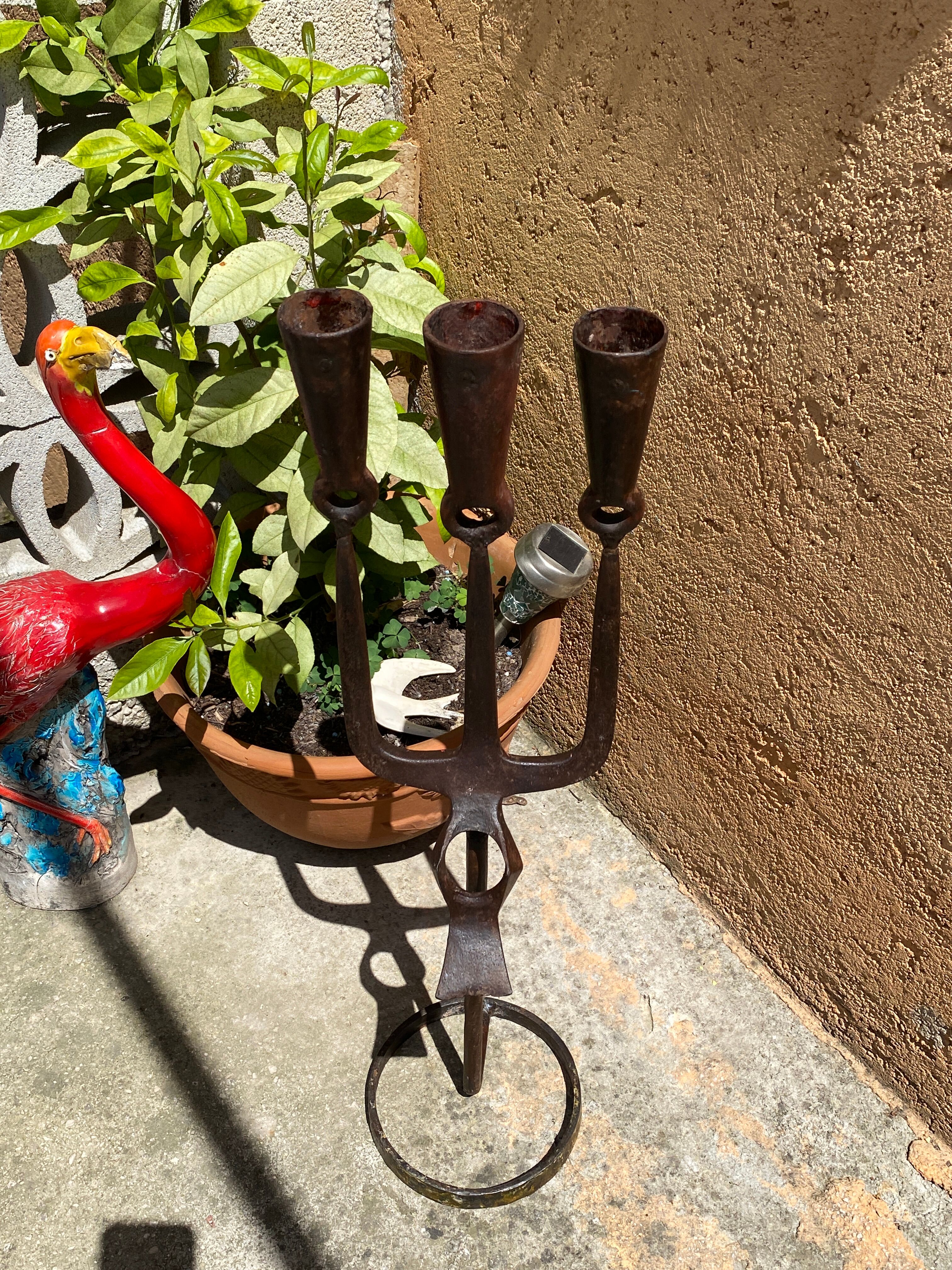 Brutalist iron candlestick on a stand