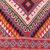 Red carpet with multicolored Berber patterns woven with hands