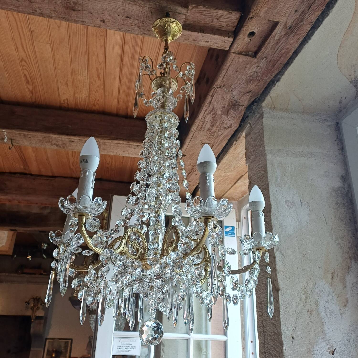 Antique chandelier with pendants in bronze and crystal.