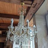 Antique chandelier with pendants in bronze and crystal.