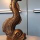 Pair of bronze dolphin candlesticks