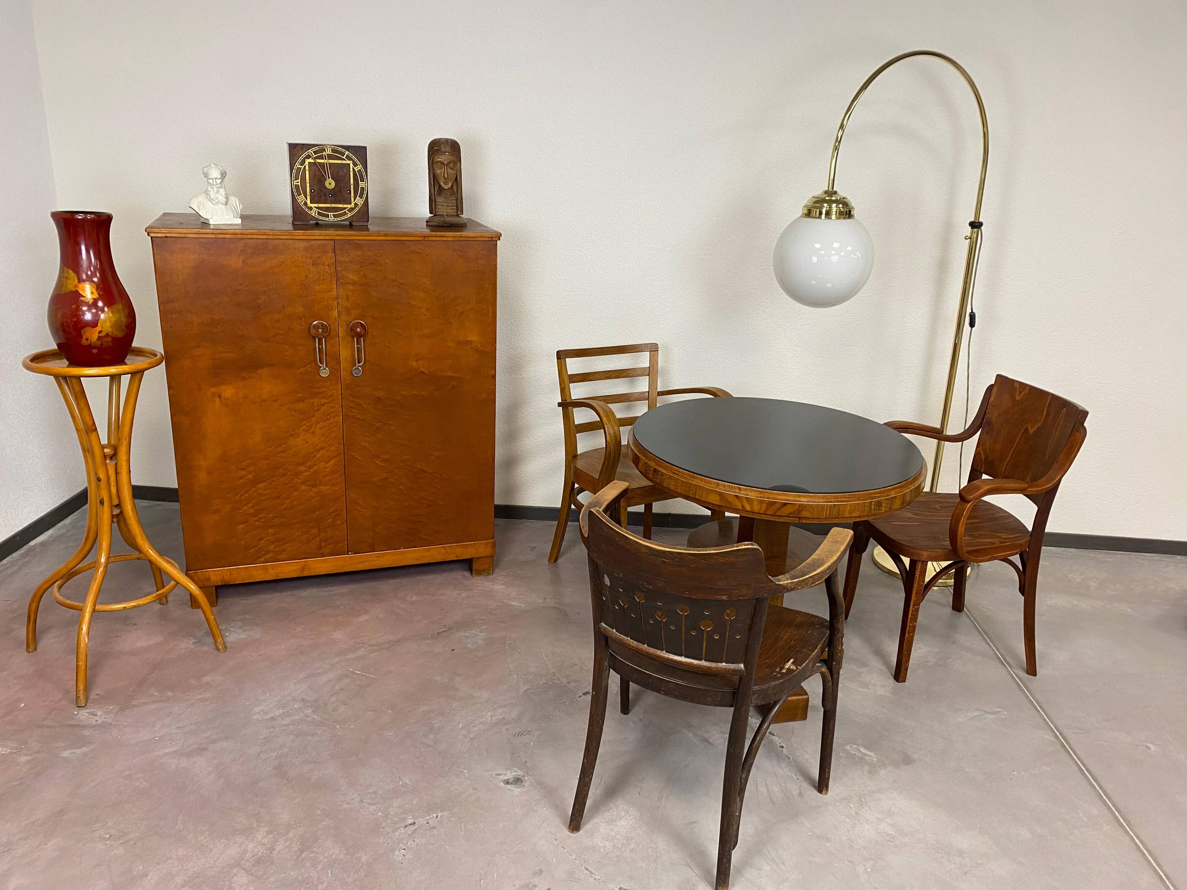 Art Deco game table with a black glass top.