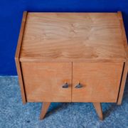 Rockabilly design bedside table with tapered legs.