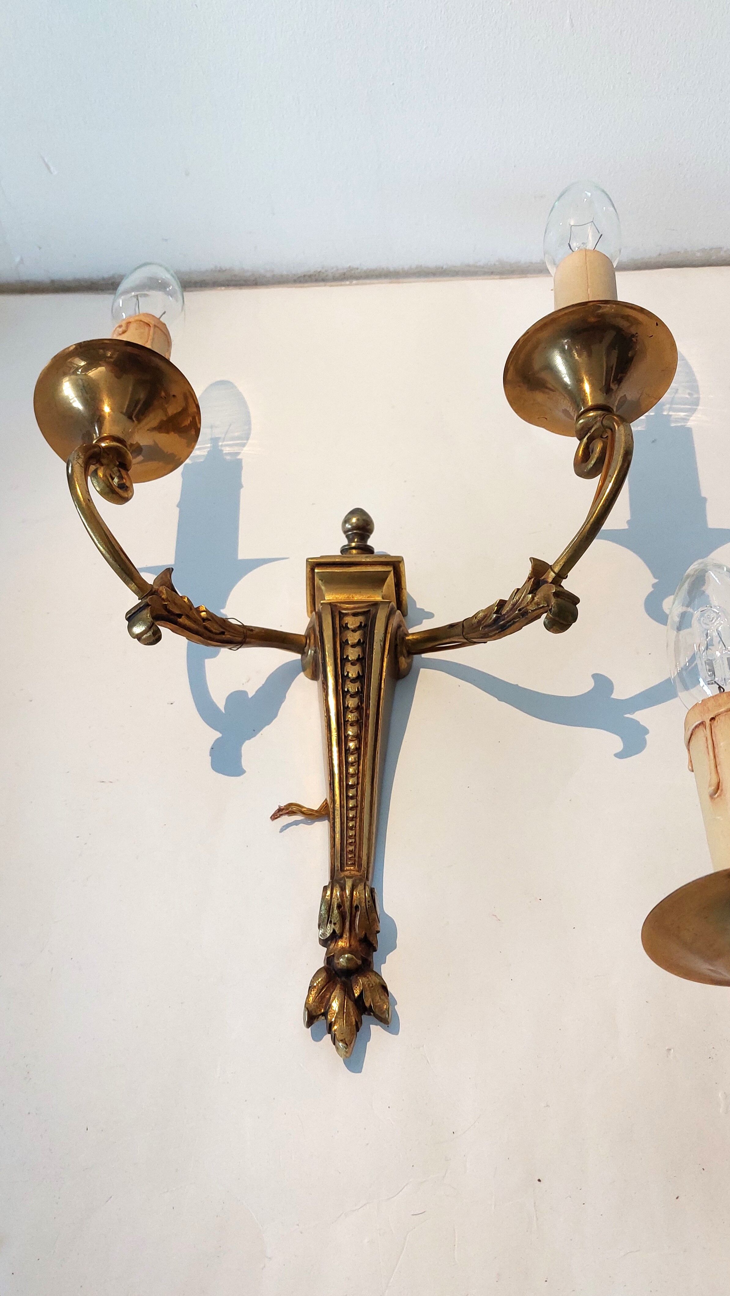 Pair of neoclassical sconces in bronze and gilded brass 1950.