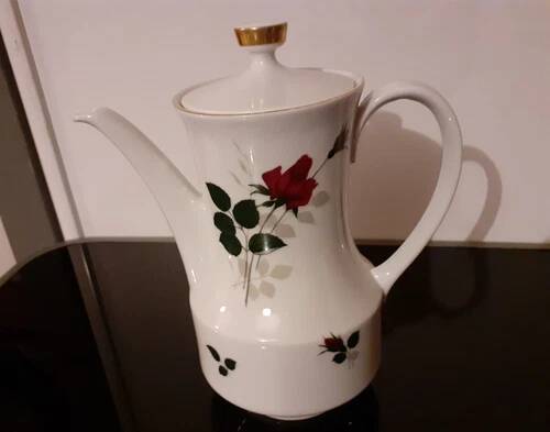 White porcelain coffee service of 3 pieces with a rose design.